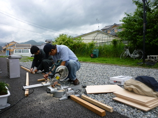 Paul assisting Micah to build a storage shelf